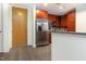 Modern kitchen with stainless steel fridge, granite countertops, and wood flooring at 618 N Boylan Ave # 520, Raleigh, NC 27603