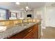 Open kitchen area with granite countertops, stainless steel sink, and view to the living room at 618 N Boylan Ave # 520, Raleigh, NC 27603