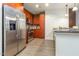Bright kitchen with stainless steel appliances, hardwood floors, and brown cabinetry at 618 N Boylan Ave # 520, Raleigh, NC 27603