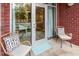 Cozy patio area with brick wall, wicker chairs, and glass doors overlooking the swimming pool at 618 N Boylan Ave # 520, Raleigh, NC 27603