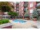 Inviting in-ground pool at red brick apartment complex with lounge chairs; a refreshing and relaxing amenity at 618 N Boylan Ave # 520, Raleigh, NC 27603