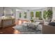 Bright living room featuring hardwood floors, large windows, and elegant furnishings at 6605 Huntingridge Rd, Chapel Hill, NC 27517
