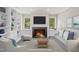 Comfortable living room with a fireplace, built-in bookshelves, and plush seating at 6605 Huntingridge Rd, Chapel Hill, NC 27517