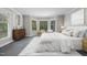 Calm main bedroom with a bay window, a wooden dresser, and neutral decor at 6605 Huntingridge Rd, Chapel Hill, NC 27517