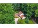 Aerial view of a charming home nestled among lush, mature trees and greenery, surrounded by natural beauty at 6701 Winding Trail Trl, Raleigh, NC 27612