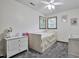 Bright bedroom with a daybed, neutral walls, and ample natural light streaming in from two windows at 6701 Winding Trail Trl, Raleigh, NC 27612