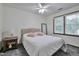 Cozy bedroom with a comfortable bed, soft carpet, neutral walls, and natural light from the window at 6701 Winding Trail Trl, Raleigh, NC 27612