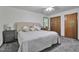 Inviting bedroom with soft carpet, neutral decor, window, and access to a closet for ample storage at 6701 Winding Trail Trl, Raleigh, NC 27612