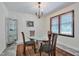Bright dining room featuring a glass table, elegant chandelier, and a large window with plenty of natural light at 6701 Winding Trail Trl, Raleigh, NC 27612
