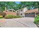 Charming two-story home featuring a brick accent wall, a large driveway, and an attached two-car garage at 6701 Winding Trail Trl, Raleigh, NC 27612