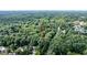 Aerial view highlights the home's location surrounded by lush greenery and mature trees at 7016 Valley Dr, Raleigh, NC 27612