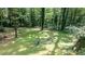Private backyard retreat featuring a hammock, bird bath, fire pit, and wooded surroundings at 7016 Valley Dr, Raleigh, NC 27612