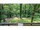 Private backyard view showcasing lush greenery, mature trees, and a relaxing hammock at 7016 Valley Dr, Raleigh, NC 27612