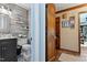 Stylish half bathroom featuring wood paneling, updated vanity, and modern fixtures at 7016 Valley Dr, Raleigh, NC 27612