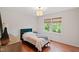 Cozy bedroom featuring a comfortable bed, and natural light from a large window at 7016 Valley Dr, Raleigh, NC 27612
