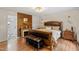 Primary bedroom featuring hardwood floors, fireplace and ensuite bathroom at 7016 Valley Dr, Raleigh, NC 27612