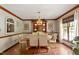 Elegant dining room with a chandelier, hardwood floors, and bright natural lighting at 7016 Valley Dr, Raleigh, NC 27612