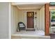 Inviting front porch featuring a decorative wreath, cozy seating, and a welcoming ambiance at 7016 Valley Dr, Raleigh, NC 27612