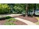 Landscaped front yard with mulch beds and a concrete walkway leading to the residence at 7016 Valley Dr, Raleigh, NC 27612