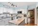 Modern kitchen with white cabinets, stainless steel appliances, and center island at 7016 Valley Dr, Raleigh, NC 27612