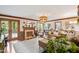 Spacious living room featuring fireplace, french doors, and woven lighting fixture at 7016 Valley Dr, Raleigh, NC 27612