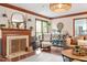 Cozy living room featuring fireplace, with elegant decor, and woven lighting fixture at 7016 Valley Dr, Raleigh, NC 27612