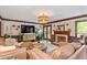Spacious living room featuring fireplace, french doors, and woven lighting fixture at 7016 Valley Dr, Raleigh, NC 27612