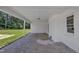 View of a back porch with white painted brick and view of yard at 802 Creech Church Rd, Kenly, NC 27542