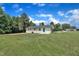 View of backyard featuring mature landscaping and green grass at 802 Creech Church Rd, Kenly, NC 27542