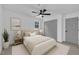 Neutral bedroom features ceiling fan, gray closet doors, and soft carpet at 802 Creech Church Rd, Kenly, NC 27542