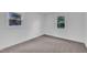 This bedroom has neutral carpet, two windows and fresh paint at 802 Creech Church Rd, Kenly, NC 27542