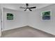 This bedroom has two windows and neutral carpet at 802 Creech Church Rd, Kenly, NC 27542