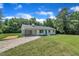 Charming single-story home with a blue door, carport, and lush green lawn at 802 Creech Church Rd, Kenly, NC 27542