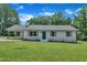 Charming single-story home featuring a painted brick facade, well-manicured lawn and a covered side entry at 802 Creech Church Rd, Kenly, NC 27542