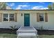 Close up of the front door framed by wooden shutters and a freshly mulched garden at 802 Creech Church Rd, Kenly, NC 27542