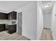 A modern kitchen adjacent to a hallway with a gray door at 802 Creech Church Rd, Kenly, NC 27542