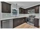 Modern kitchen with stainless steel appliances, quartz countertops, and dark wood cabinets with gold hardware at 802 Creech Church Rd, Kenly, NC 27542