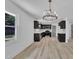 A spacious kitchen with dark cabinets, a window, and a chandelier at 802 Creech Church Rd, Kenly, NC 27542