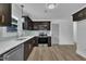 Modern kitchen with stainless steel appliances, quartz countertops and dark wood cabinetry and wood-look floors at 802 Creech Church Rd, Kenly, NC 27542