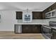 View of the kitchen with stainless steel appliances, dark cabinets, and light counters at 802 Creech Church Rd, Kenly, NC 27542