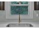 Close-up of kitchen sink with bronze faucet, with an outdoor view from the window at 802 Creech Church Rd, Kenly, NC 27542