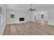 An empty living room featuring fireplace and updated flooring at 802 Creech Church Rd, Kenly, NC 27542