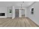 Open-concept living and dining area, featuring lots of natural light, wood-look floors and modern light fixture at 802 Creech Church Rd, Kenly, NC 27542