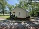 Shows the back of a one story home with vinyl siding and a small covered patio at 981 Leasburg Rd, Roxboro, NC 27573
