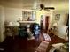 A simple living room with an ornamental fireplace, ceiling fan, and comfortable furniture at 981 Leasburg Rd, Roxboro, NC 27573