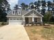 Charming single Gathering home featuring a two-car garage and manicured front lawn at 105 Slippery Elm Rd, Youngsville, NC 27596