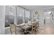 Dining room with a wooden table, seating for six, and natural light from large windows at 1101 Shovelhead Dr # 51, Durham, NC 27703