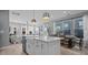 Bright kitchen island with white countertops and ample seating overlooking dining and living area at 1101 Shovelhead Dr # 51, Durham, NC 27703