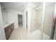 Modern bathroom featuring tiled shower with glass door and double vanity at 1108 Matterhorn Dr, Fuquay Varina, NC 27526