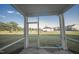 Screened patio looking out to a expansive green lawn with a pool and trees at 1108 Matterhorn Dr, Fuquay Varina, NC 27526